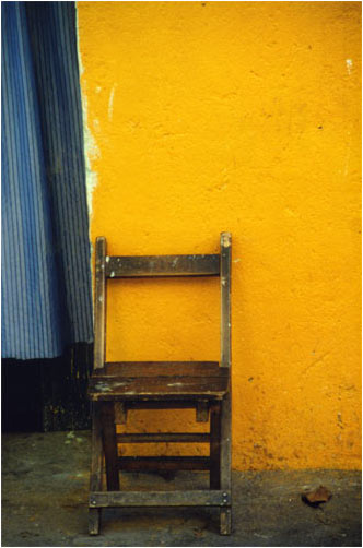 Chair against Orange Wall by Joan Francis Photography